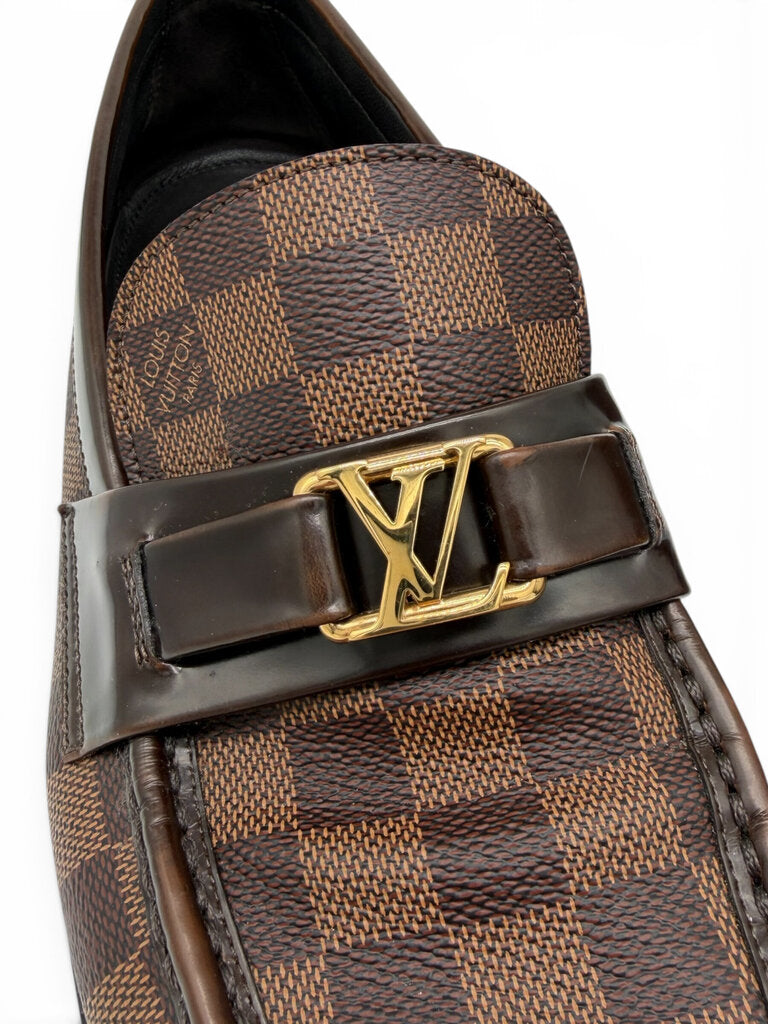 Detailed view of Louis Vuitton men's Damier Ebene loafer with gold LV emblem, polished leather strap and coated canvas. From designer consignment boutique, Dee Black, in Perth, Western Australia.