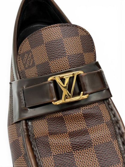 Detailed view of Louis Vuitton men's Damier Ebene loafer with gold LV emblem, polished leather strap and coated canvas. From designer consignment boutique, Dee Black, in Perth, Western Australia.