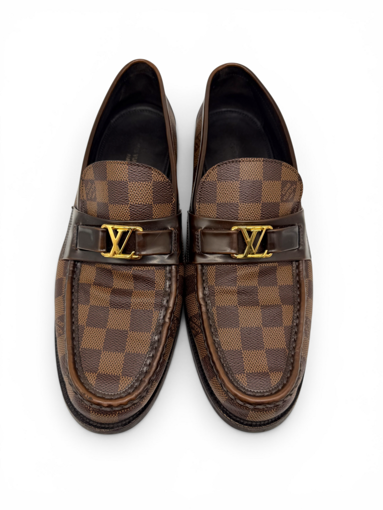 Men's designer loafers in brown checkered canvas with gold logo detail and classic slip-on silhouette, from Dee Black Boutique, Perth. 